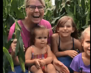 Susie and grandbabies with sweet corn